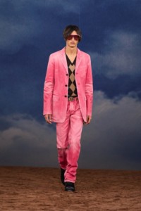 Burberry SS26 Show model Ruben Bilan Carroll wearing a pink Coated denim tailored jacket and Argyle knit vest