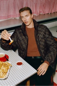 Shot of model Lucky Blue Smith wearing Reversible Check Snowdon Puffer Jacket in colour Truffle Brown