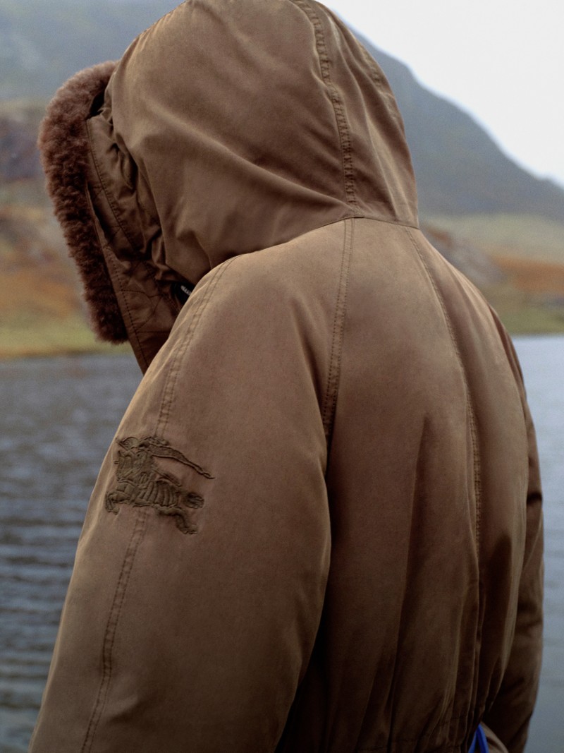 Male model wearing a Burberry Jacket for the Gabardine 2026 Collection, stood by loch and forest area 