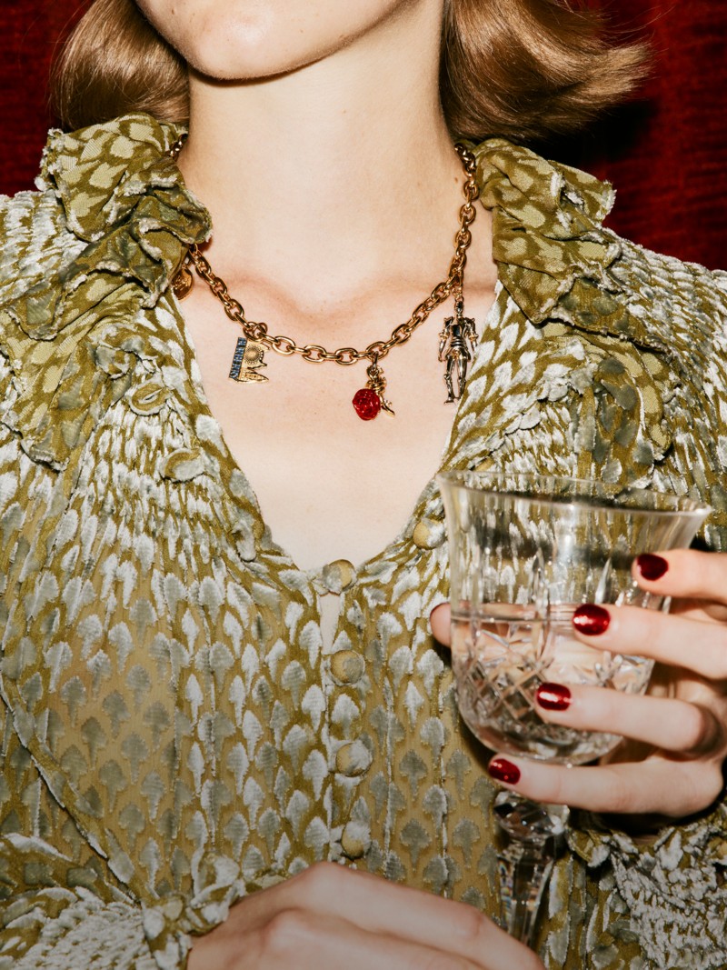 Burberry Festive Campaign featuring a model wearing Burberry Women's golden charm necklace. 