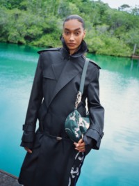 Female Model wearing Black Trench coat with Knight bag