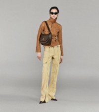 Model wearing Jacket in Sand with Cargo Trousers, Black Mules and the Medium Rocking Horse Bag