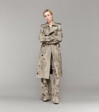 Modella che indossa un trench in pelle scamosciata, pullover con scollo a V e pantaloni in pelle scamosciata color Heron