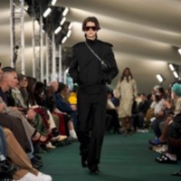 테일러드 팬츠, 쉴드 로퍼, 트렌치 재킷을 착용한 모델.
