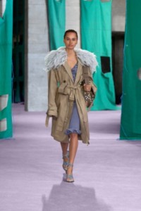 Model wearing Faux feather trim silk poplin zip car coat in paddock with ribbed silk dress in whale.