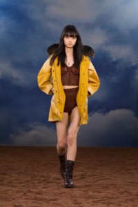 Burberry SS26 Show model Shuqi Lan wearing a Fringed waxed cotton parka and Crochet knit top and shorts