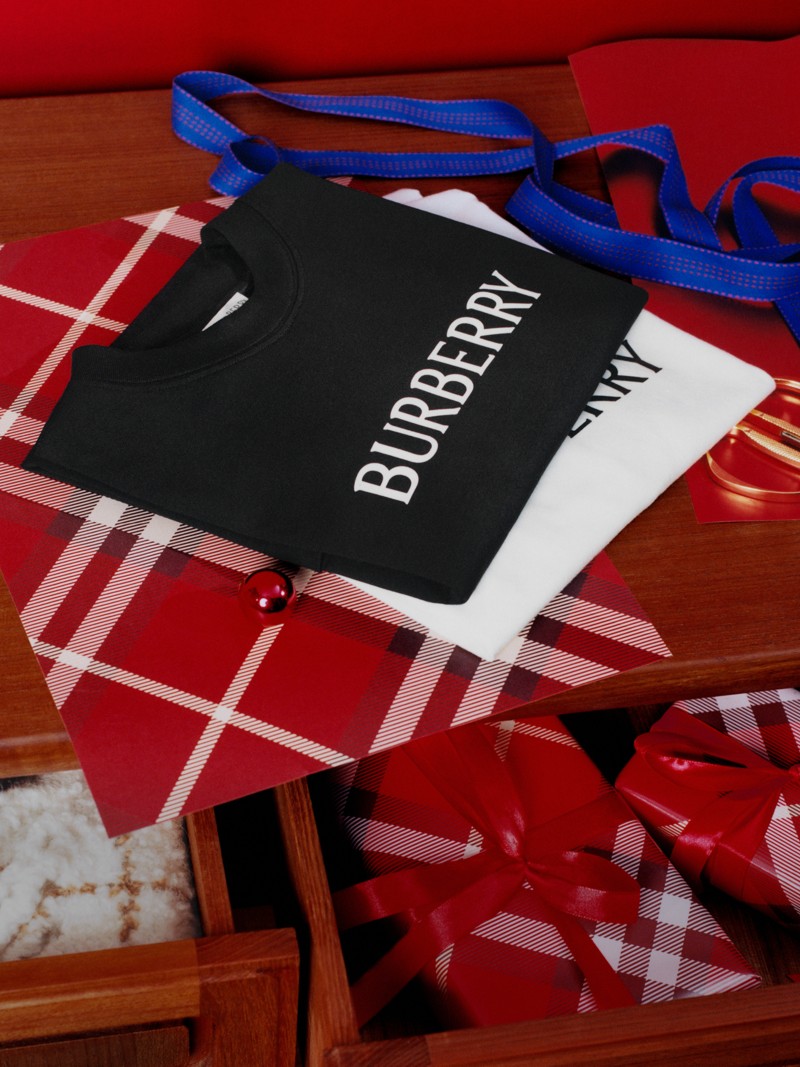 Burberry's Festive Gifting Campaign featuring Burberry logo t-shirts on festive wrapping.
