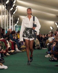 Model wearing a Shirt with Knight hardware print shorts and London Zip pumps.