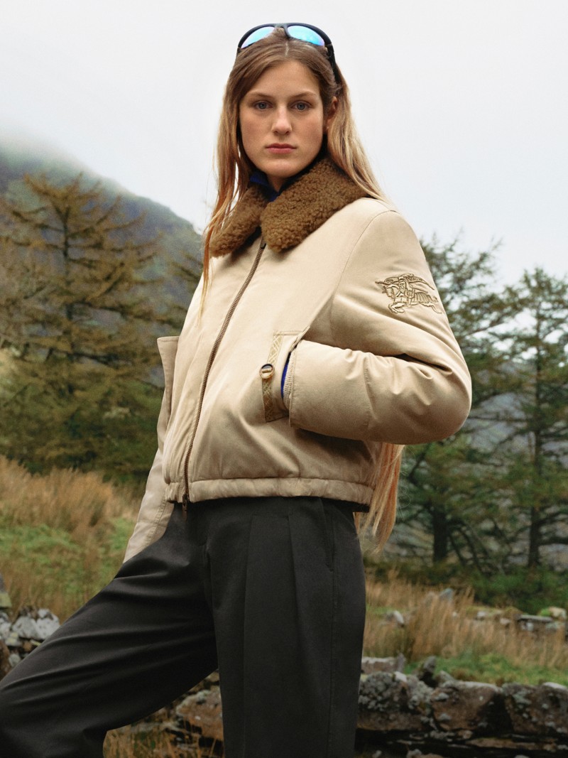 Female model wearing a Burberry Jacket from the Gabardine 2026 Collection, stood in forest landscape